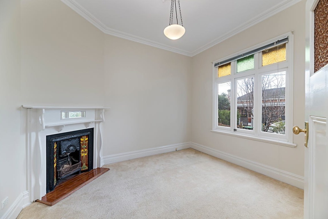 Before digital staging: empty open-plan dining space showing architectural proportions