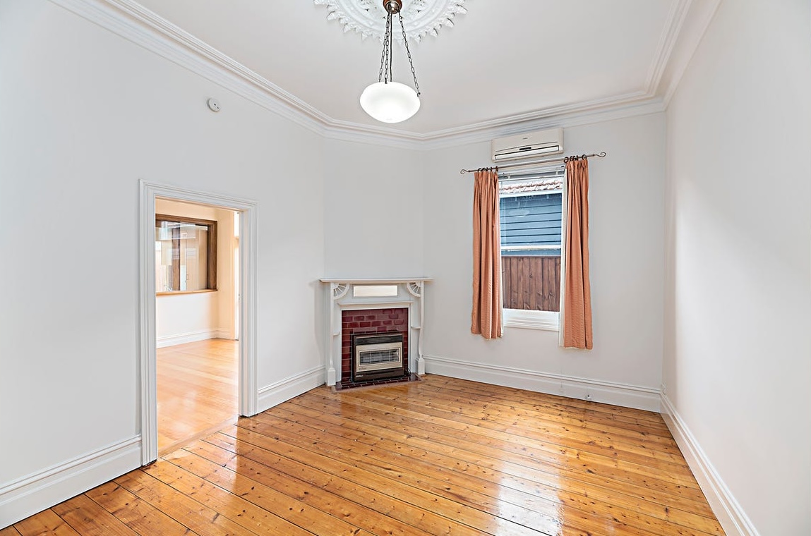 Before virtual staging: vacant Australian living room with bare timber floors and neutral walls for real estate marketing